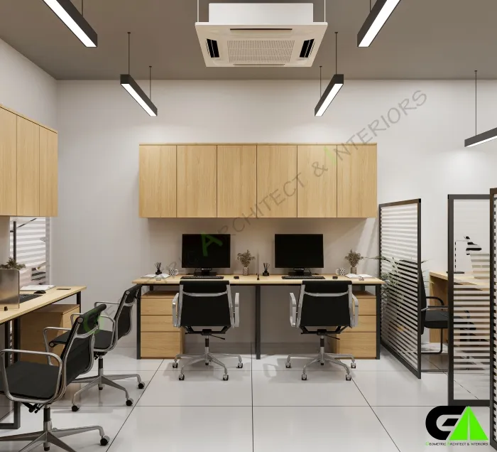 Shared workstations in small office in Mirpur featuring dual monitors, black chairs and wood cabinets